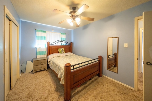 carpeted bedroom with ceiling fan and a closet