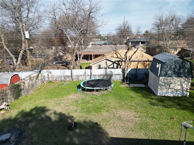 view of yard with a storage shed and a trampoline