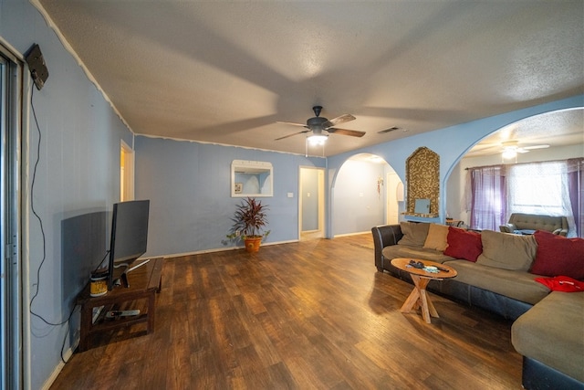 living room with ceiling fan, wood-type flooring, and a textured ceiling