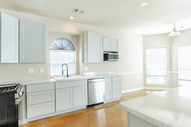 kitchen featuring gray cabinetry, sink, and stainless steel appliances