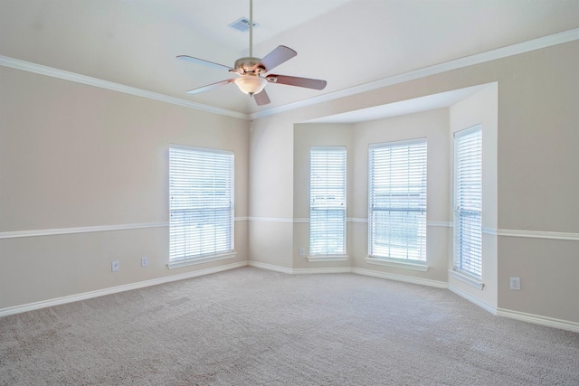 carpeted spare room with ceiling fan and ornamental molding