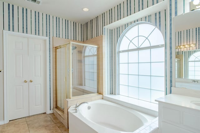 bathroom featuring tile patterned floors, vanity, and plus walk in shower