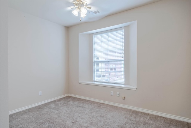 unfurnished room featuring ceiling fan and light colored carpet