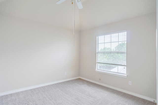 carpeted spare room with ceiling fan