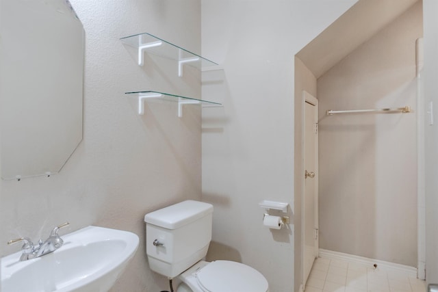 bathroom with sink, vaulted ceiling, and toilet