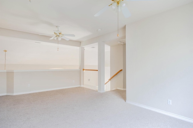 carpeted spare room featuring ceiling fan