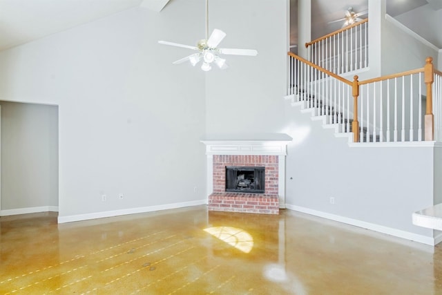 unfurnished living room with ceiling fan, a fireplace, and high vaulted ceiling