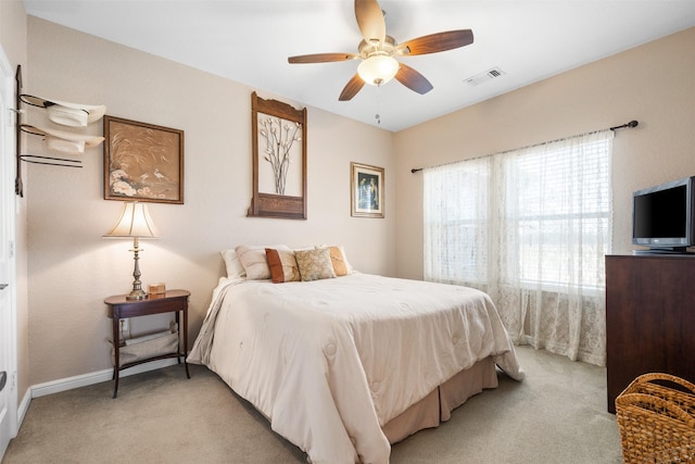 bedroom with ceiling fan and light carpet