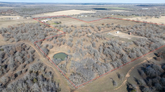 drone / aerial view featuring a water view and a rural view