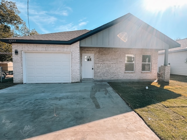 single story home with a front yard and a garage