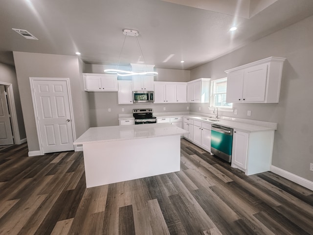 kitchen featuring white cabinets, sink, a kitchen island, and stainless steel appliances