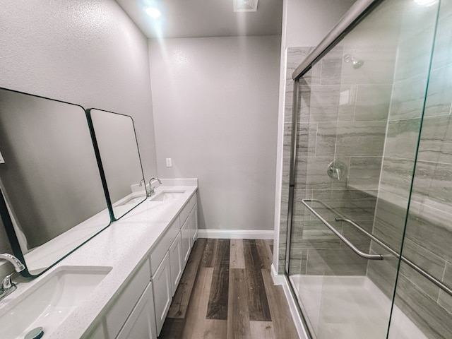 bathroom featuring vanity, hardwood / wood-style flooring, and an enclosed shower