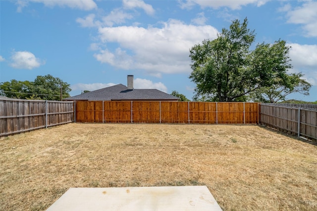 view of yard with a fenced backyard