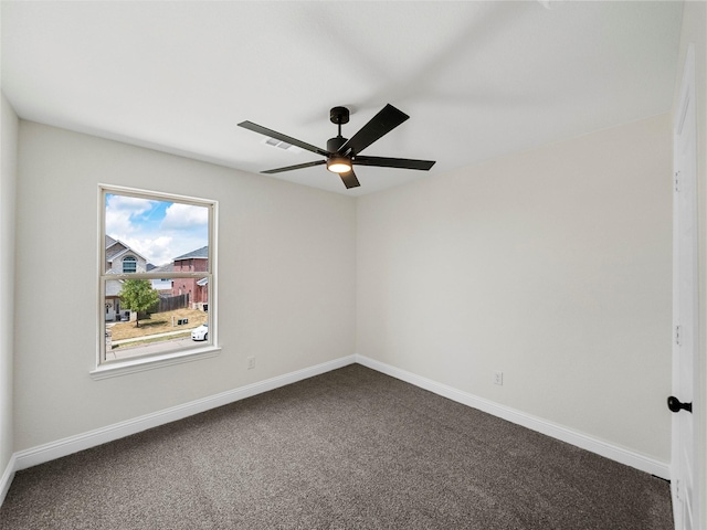 carpeted empty room featuring ceiling fan