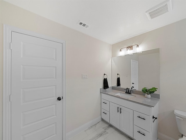 bathroom with marble finish floor, visible vents, vanity, and toilet