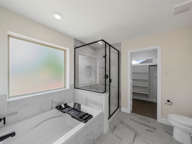 bathroom featuring toilet, plenty of natural light, and plus walk in shower