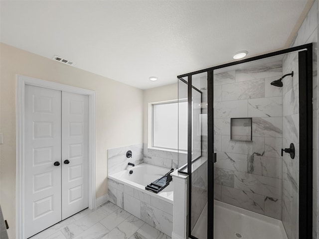 bathroom with separate shower and tub