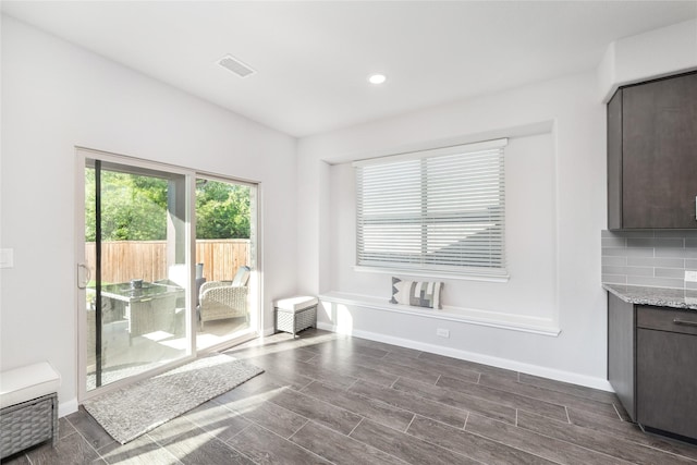 bathroom featuring vanity and backsplash