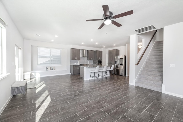 unfurnished living room featuring ceiling fan