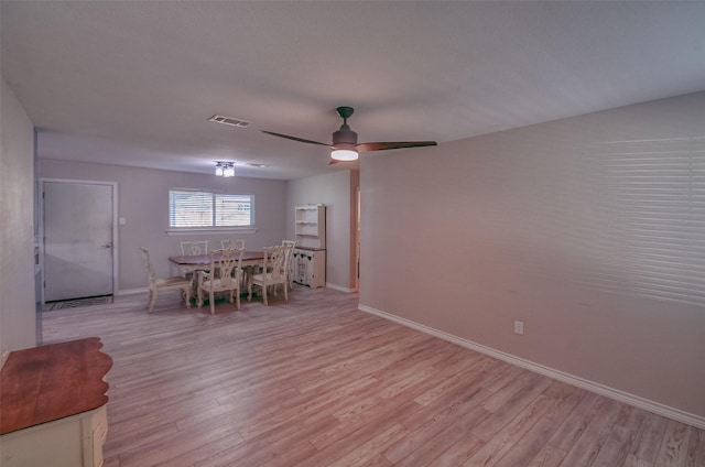 unfurnished dining area featuring ceiling fan and light hardwood / wood-style floors