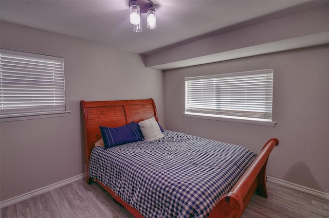 bedroom with light wood-type flooring and ceiling fan