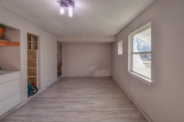 interior space featuring washer / clothes dryer and light hardwood / wood-style floors