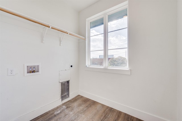 clothes washing area with washer hookup, a fireplace, hardwood / wood-style floors, and electric dryer hookup