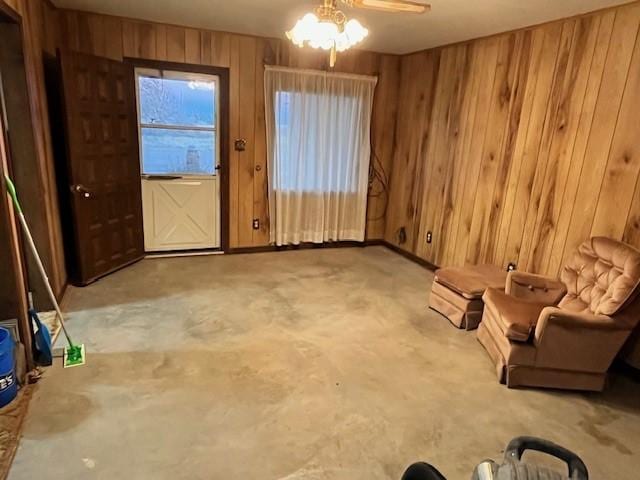 interior space with wooden walls and ceiling fan