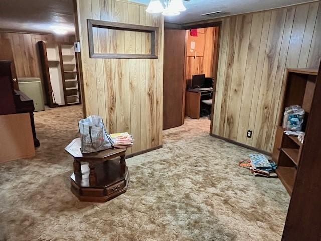 interior space with carpet flooring and wooden walls