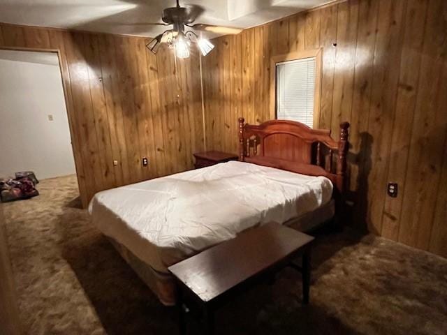 bedroom with carpet floors, wooden walls, and ceiling fan