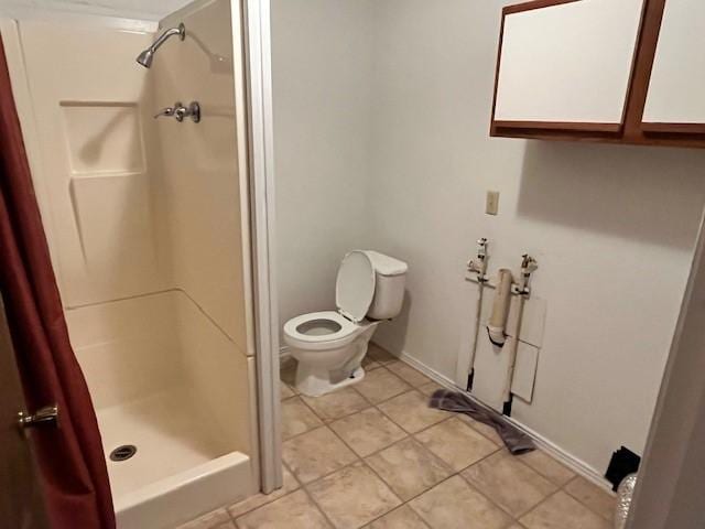 bathroom featuring toilet and walk in shower