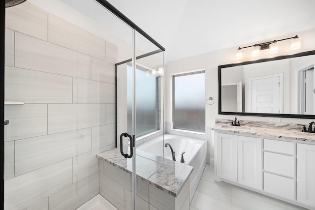 bathroom featuring vanity and independent shower and bath