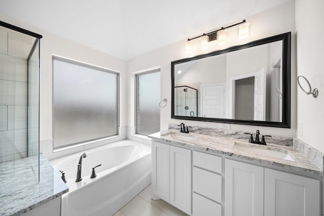 bathroom with tile patterned floors, vanity, and plus walk in shower