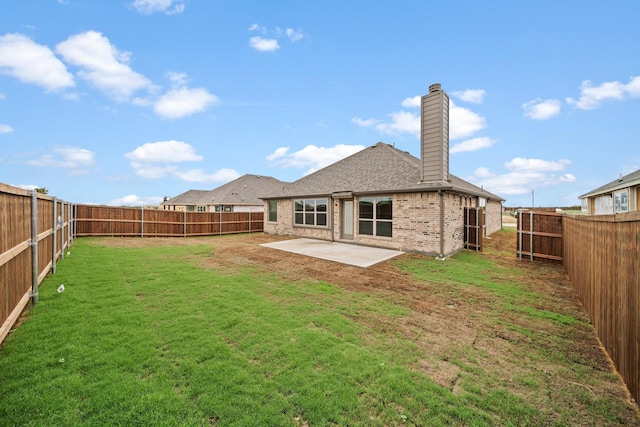 back of property featuring a lawn and a patio area