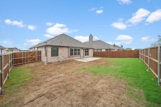 back of house featuring a patio and a lawn