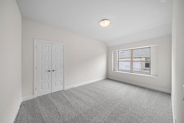 spare room with lofted ceiling and carpet floors