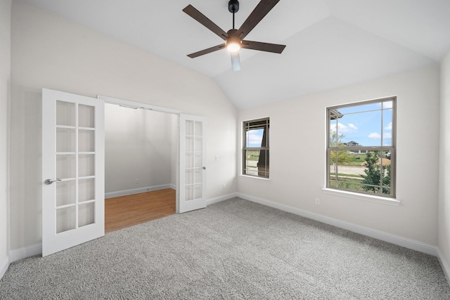 unfurnished bedroom with french doors, carpet floors, ceiling fan, and lofted ceiling