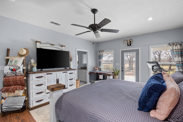 bedroom featuring access to exterior, ensuite bath, ceiling fan, and dark wood-type flooring