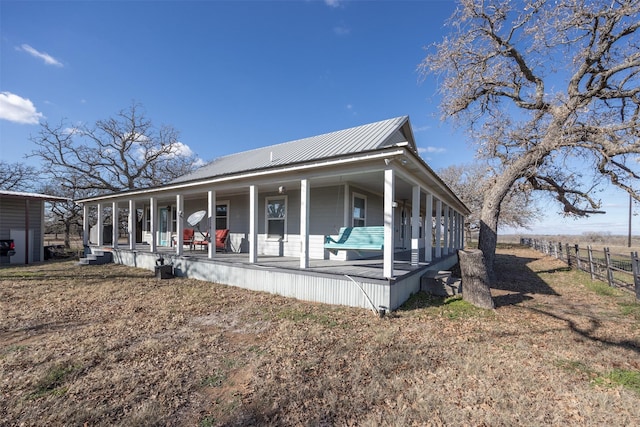 rear view of property featuring a porch