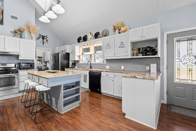 kitchen featuring hanging light fixtures, a kitchen island, dark hardwood / wood-style flooring, white cabinets, and black appliances