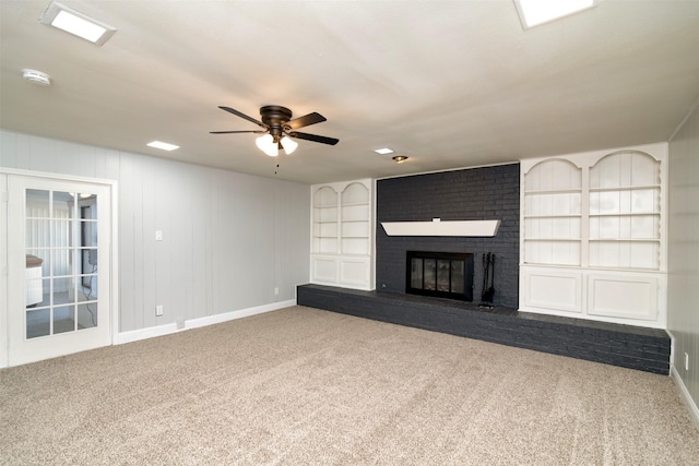 unfurnished living room featuring light carpet, a brick fireplace, and ceiling fan