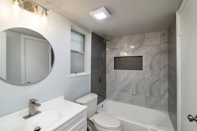 full bathroom featuring vanity, toilet, and tiled shower / bath