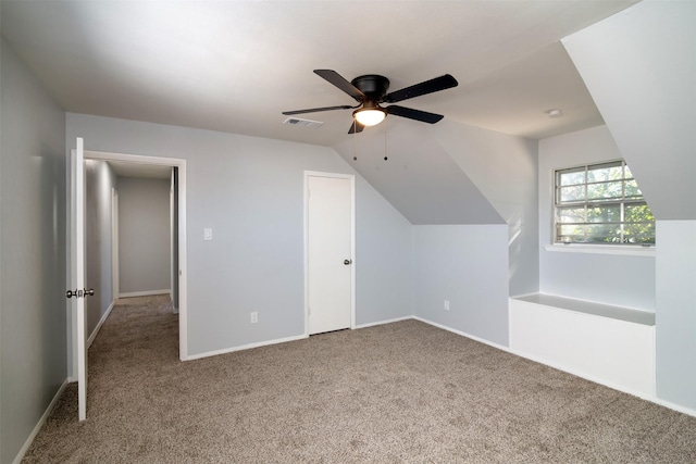 additional living space featuring carpet flooring, ceiling fan, and vaulted ceiling