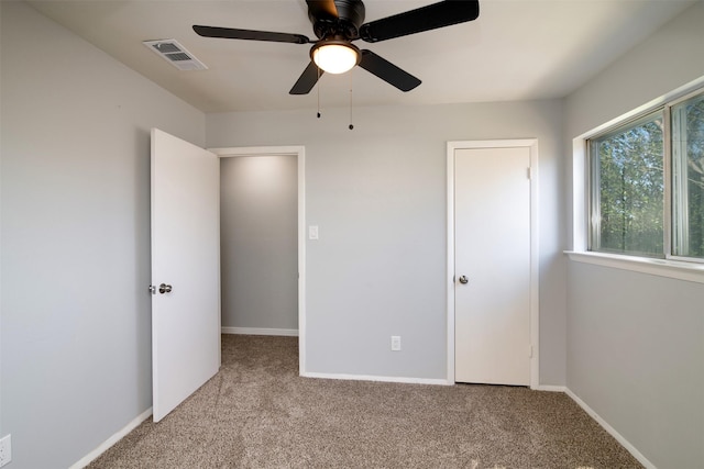 unfurnished bedroom featuring ceiling fan and light colored carpet