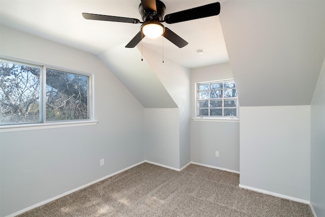 additional living space featuring ceiling fan, light carpet, and vaulted ceiling