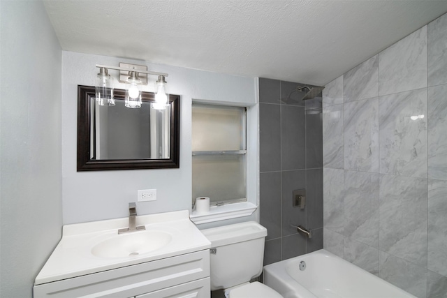 full bathroom featuring a textured ceiling, vanity, toilet, and tiled shower / bath