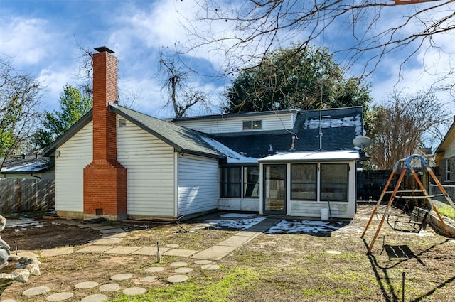 back of house featuring a sunroom