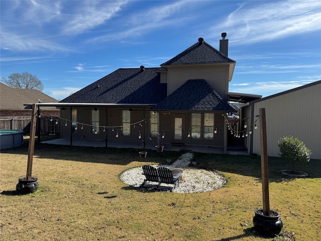 rear view of house featuring a yard and a patio