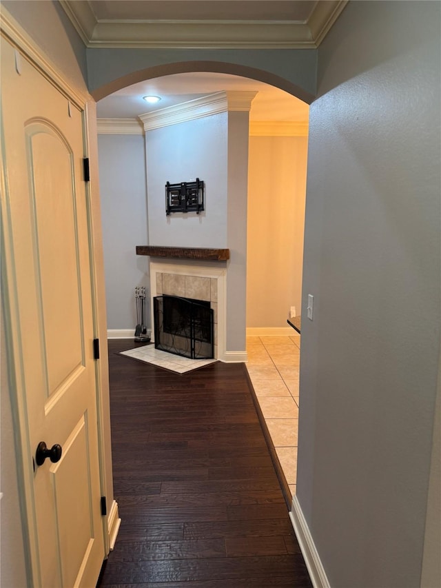 hall with hardwood / wood-style flooring and crown molding