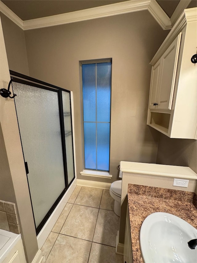 bathroom featuring vanity, a shower with door, tile patterned floors, crown molding, and toilet